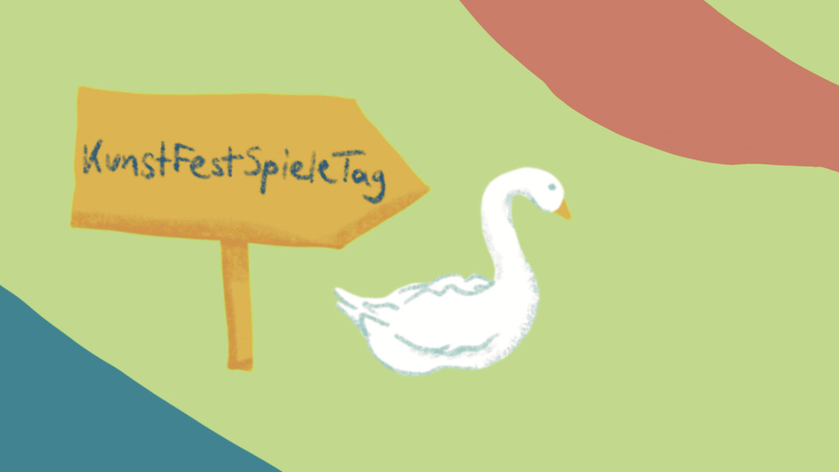 Ein Hinweisschild auf grüner Wiese auf dem Kunstfestspieletag steht. Ein Schwan steht neben dem Schild.